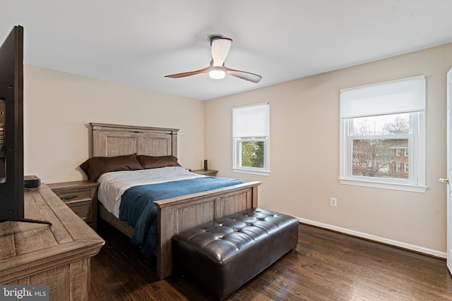 bedroom with a ceiling fan, baseboards, and dark wood-style flooring