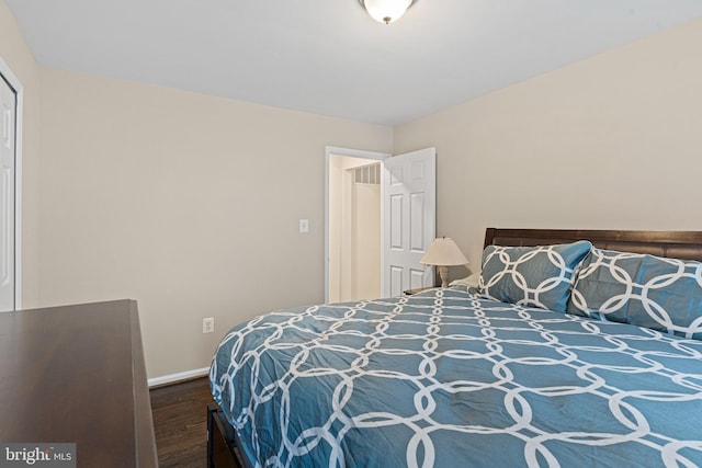 bedroom with wood finished floors and baseboards