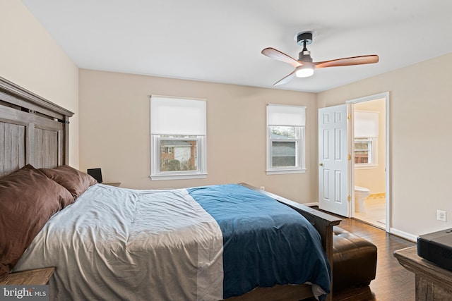 bedroom with ceiling fan, baseboards, ensuite bath, and wood finished floors