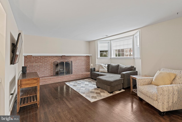 living area featuring wood finished floors and a fireplace