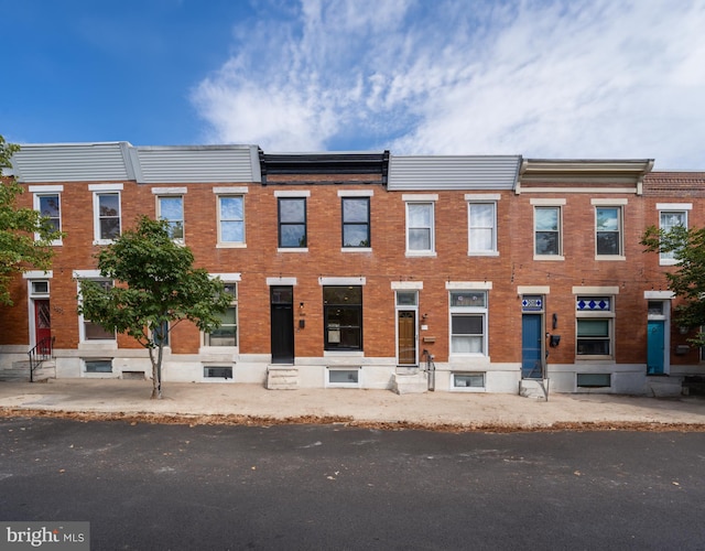 view of front facade featuring brick siding and entry steps