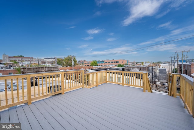 wooden deck featuring a view of city