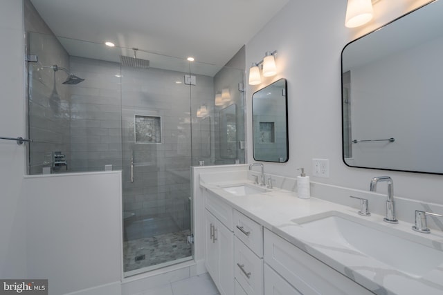 bathroom featuring a sink, recessed lighting, a stall shower, and double vanity