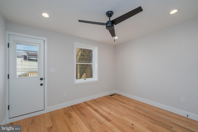 spare room featuring light wood-style flooring, recessed lighting, a ceiling fan, and baseboards