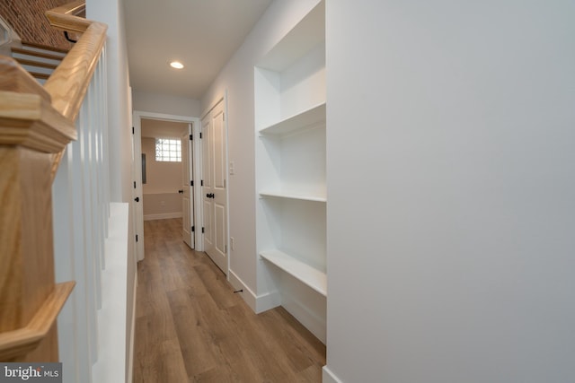 hallway featuring recessed lighting, baseboards, and light wood-style flooring