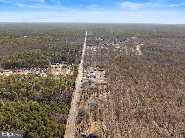 birds eye view of property with a wooded view