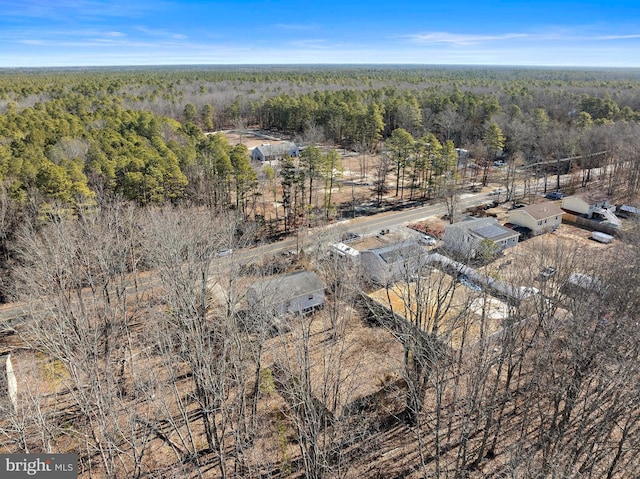 drone / aerial view with a wooded view