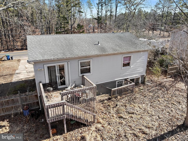 back of property with stairs, a wooden deck, fence, and a shingled roof