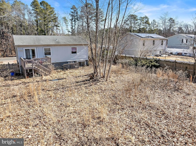 rear view of house featuring fence