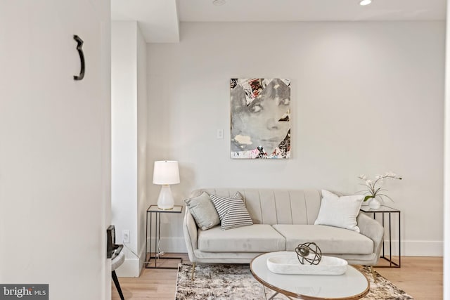 living room with recessed lighting, light wood-style floors, and baseboards