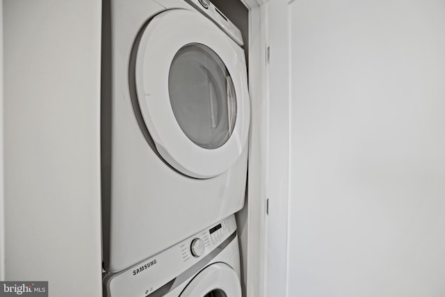 laundry area featuring stacked washer and dryer and laundry area