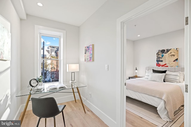 bedroom with recessed lighting, light wood-type flooring, and baseboards