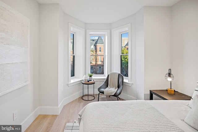 bedroom featuring wood finished floors and baseboards