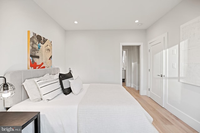 bedroom featuring recessed lighting, light wood-type flooring, and baseboards