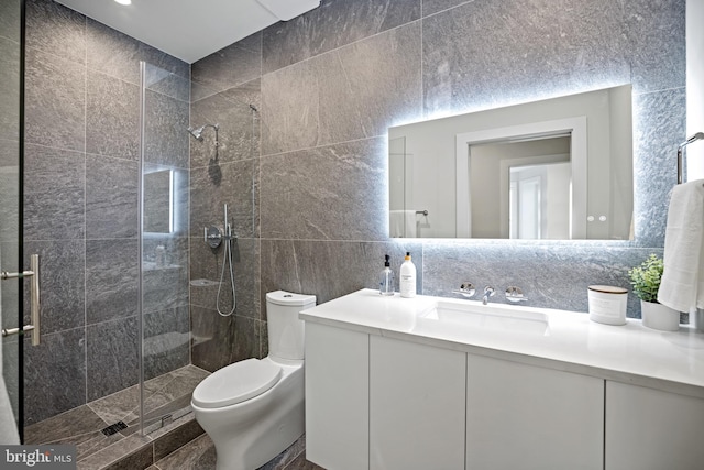 full bath with vanity, a shower stall, tile walls, toilet, and backsplash