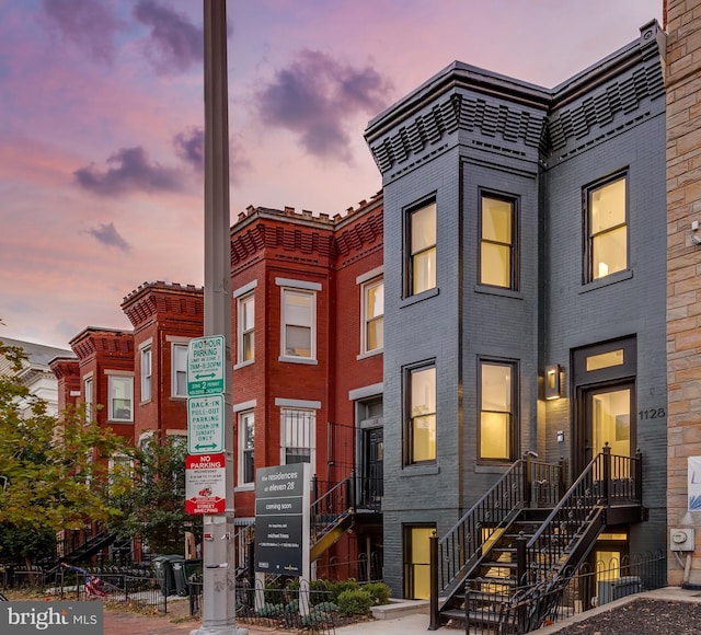 townhome / multi-family property featuring brick siding and fence