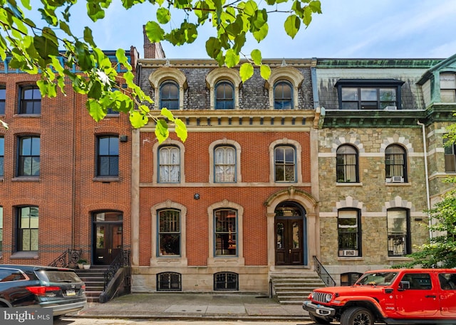 view of front facade with mansard roof