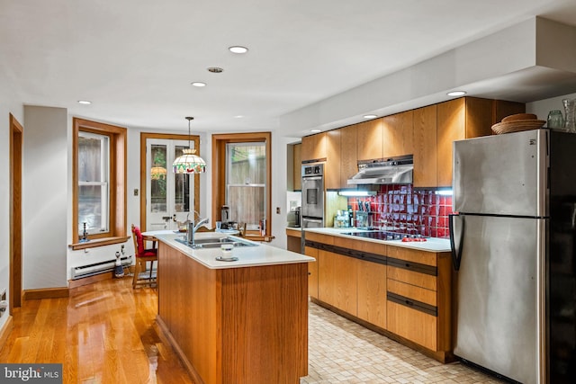 kitchen with a sink, ventilation hood, stainless steel appliances, light countertops, and a baseboard radiator