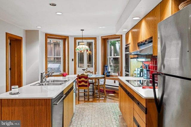 kitchen with a sink, brown cabinets, and stainless steel appliances