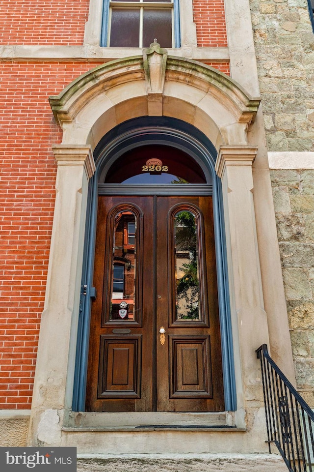 property entrance with stone siding