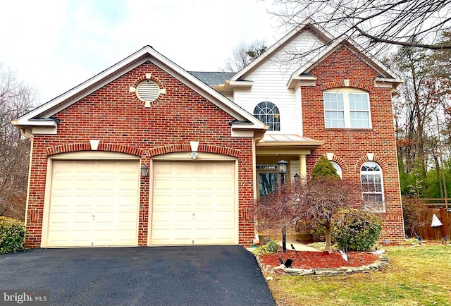 traditional-style home with aphalt driveway, an attached garage, and brick siding