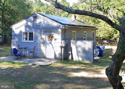 rear view of house featuring a patio and a chimney