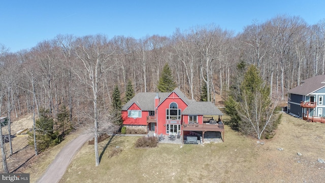 birds eye view of property featuring a view of trees