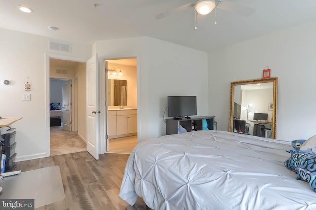 bedroom with recessed lighting, wood finished floors, visible vents, and ensuite bathroom