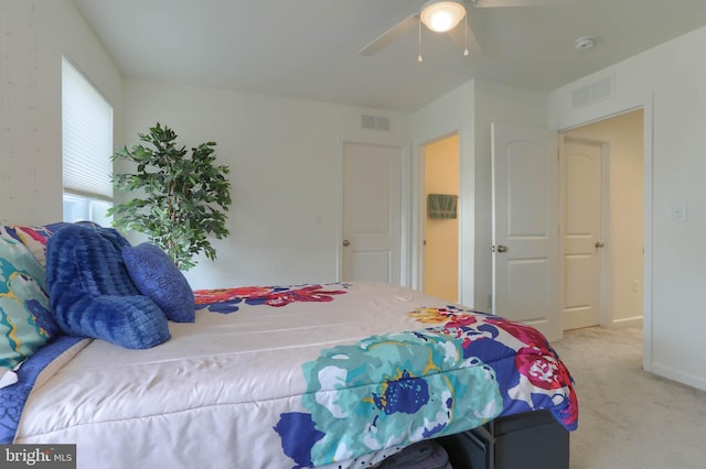 bedroom with a ceiling fan, visible vents, and carpet floors