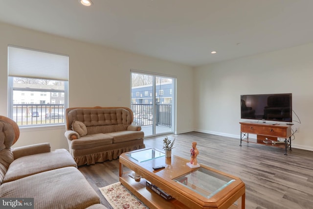 living room with recessed lighting, wood finished floors, and baseboards