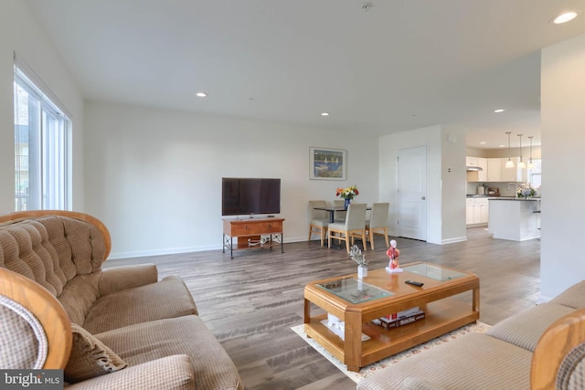 living room with recessed lighting, wood finished floors, and baseboards