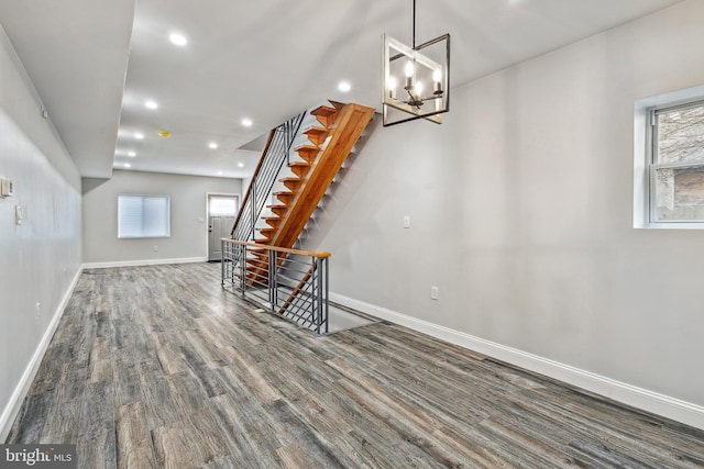 interior space with recessed lighting, plenty of natural light, wood finished floors, and baseboards