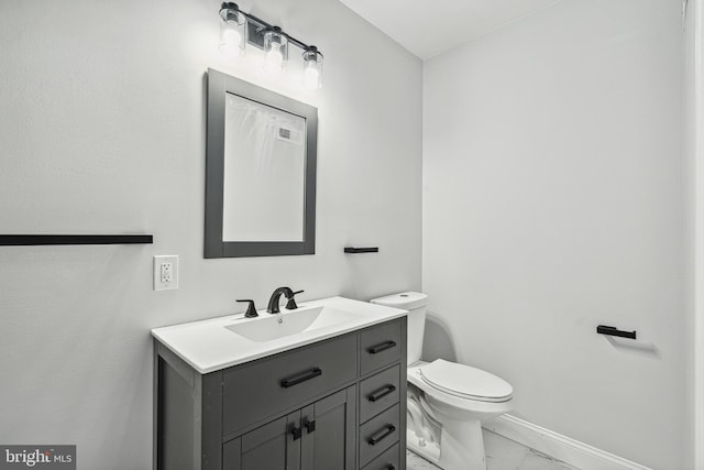 bathroom with visible vents, baseboards, toilet, marble finish floor, and vanity