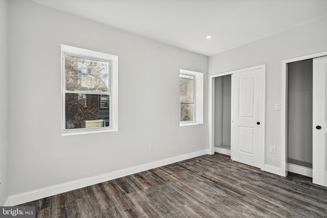 unfurnished bedroom with recessed lighting, baseboards, and dark wood-style flooring