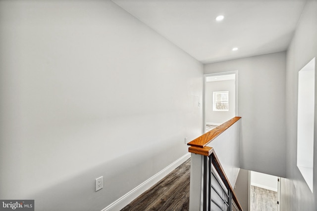 hall featuring recessed lighting, baseboards, an upstairs landing, and dark wood-style flooring