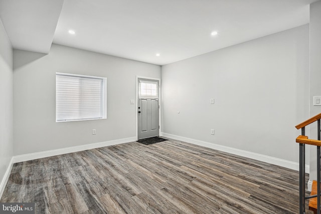 foyer with recessed lighting, baseboards, and wood finished floors