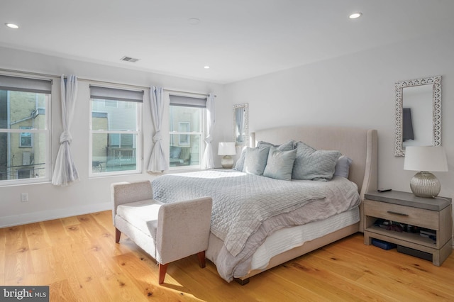 bedroom with recessed lighting, visible vents, light wood-style flooring, and baseboards