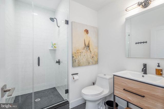 bathroom with vanity, a shower stall, and toilet