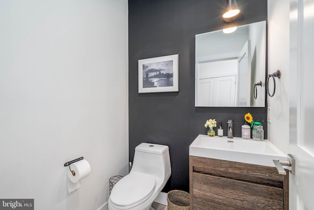 half bathroom featuring toilet and vanity