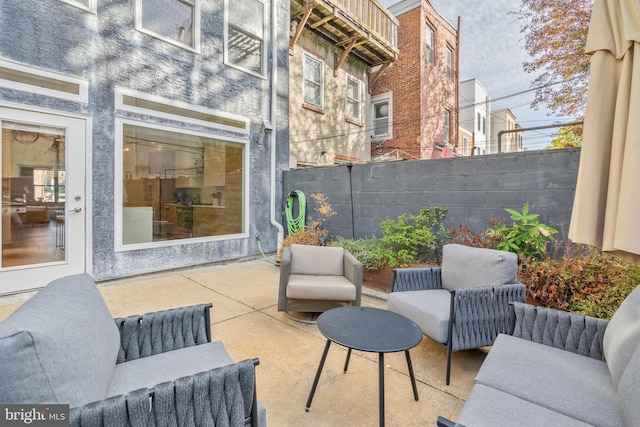 view of patio featuring an outdoor living space and fence