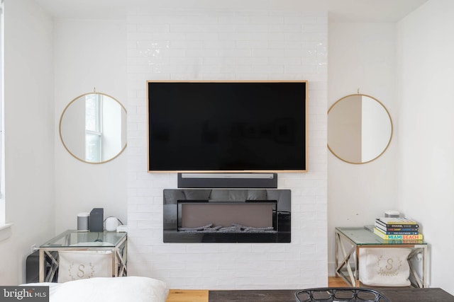 interior details with wood finished floors and a fireplace