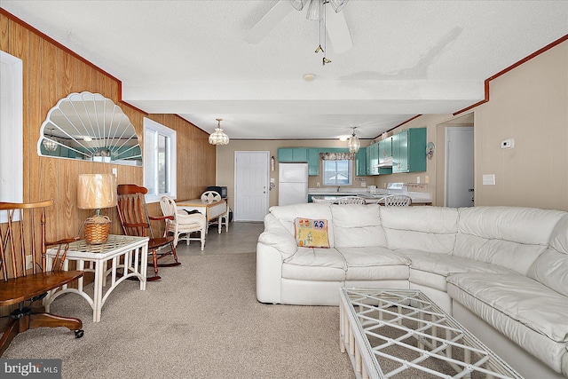 living area featuring wood walls, a textured ceiling, and a ceiling fan