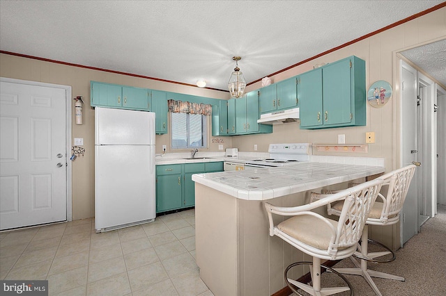 kitchen with crown molding, under cabinet range hood, white appliances, a textured ceiling, and a sink