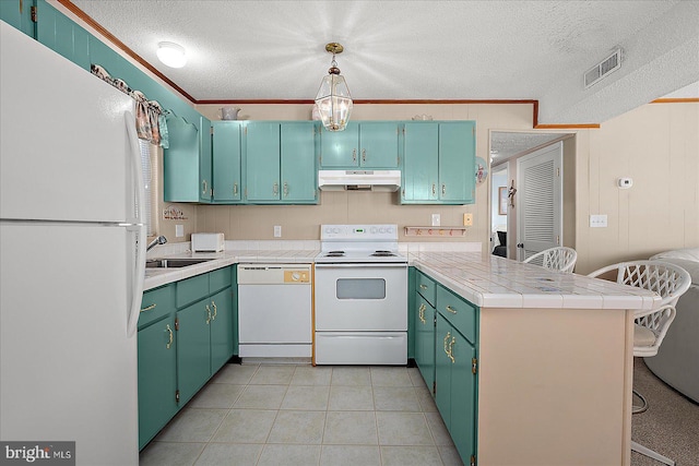 kitchen with white appliances, visible vents, a peninsula, under cabinet range hood, and crown molding