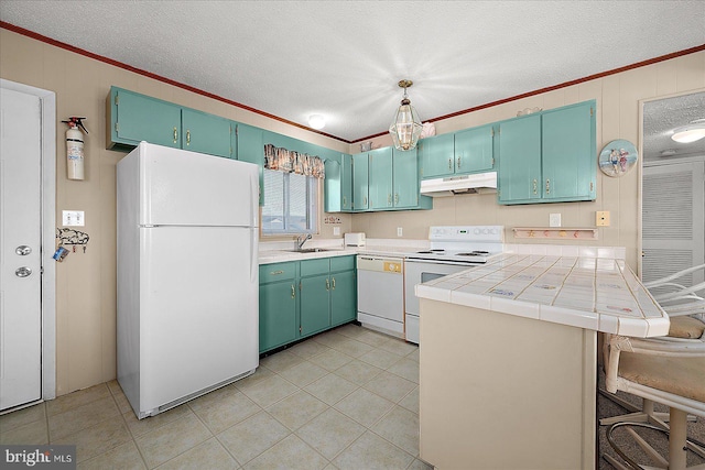 kitchen with under cabinet range hood, white appliances, ornamental molding, and a sink