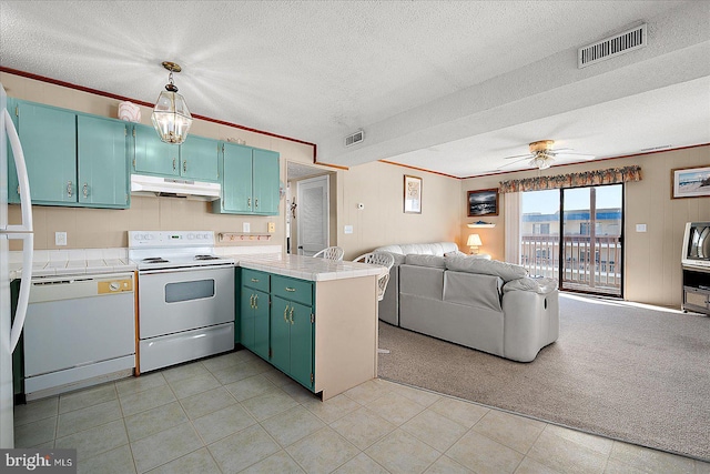 kitchen with visible vents, under cabinet range hood, open floor plan, white appliances, and a peninsula