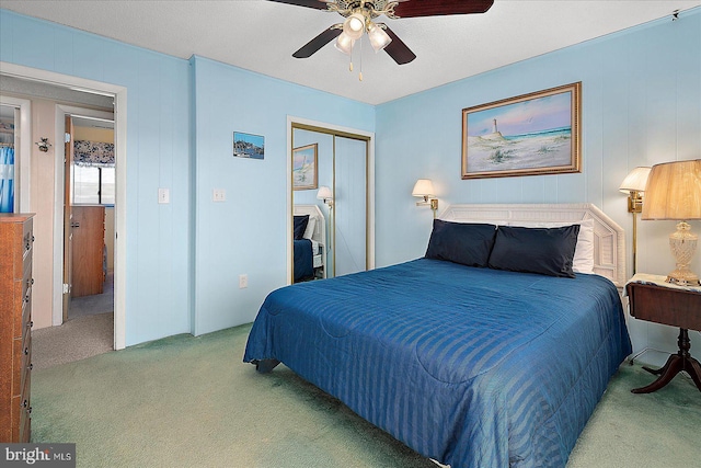 carpeted bedroom featuring a ceiling fan and a closet