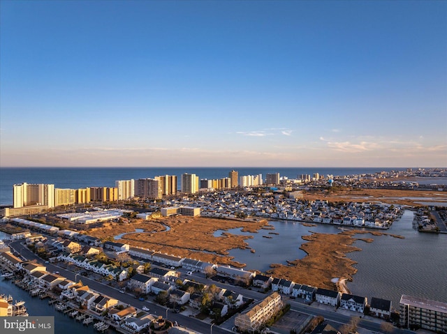 aerial view at dusk with a water view and a view of city