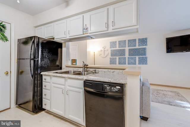 kitchen with black appliances, white cabinets, and a sink