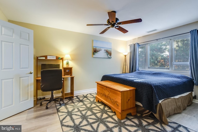 bedroom featuring a ceiling fan, light wood-style flooring, baseboards, and visible vents